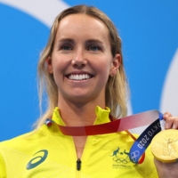 Emma McKeon of Australia poses on the podium with her gold medal in the women\'s 100-meter freestyle.  | REUTERS
