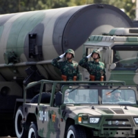 People\'s Liberation Army soldiers salute in front of nuclear-capable missiles during a parade in Beijing in 2009.  | REUTERS