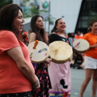 Women sing and play drums in Toronto on Thursday.  | REUTERS