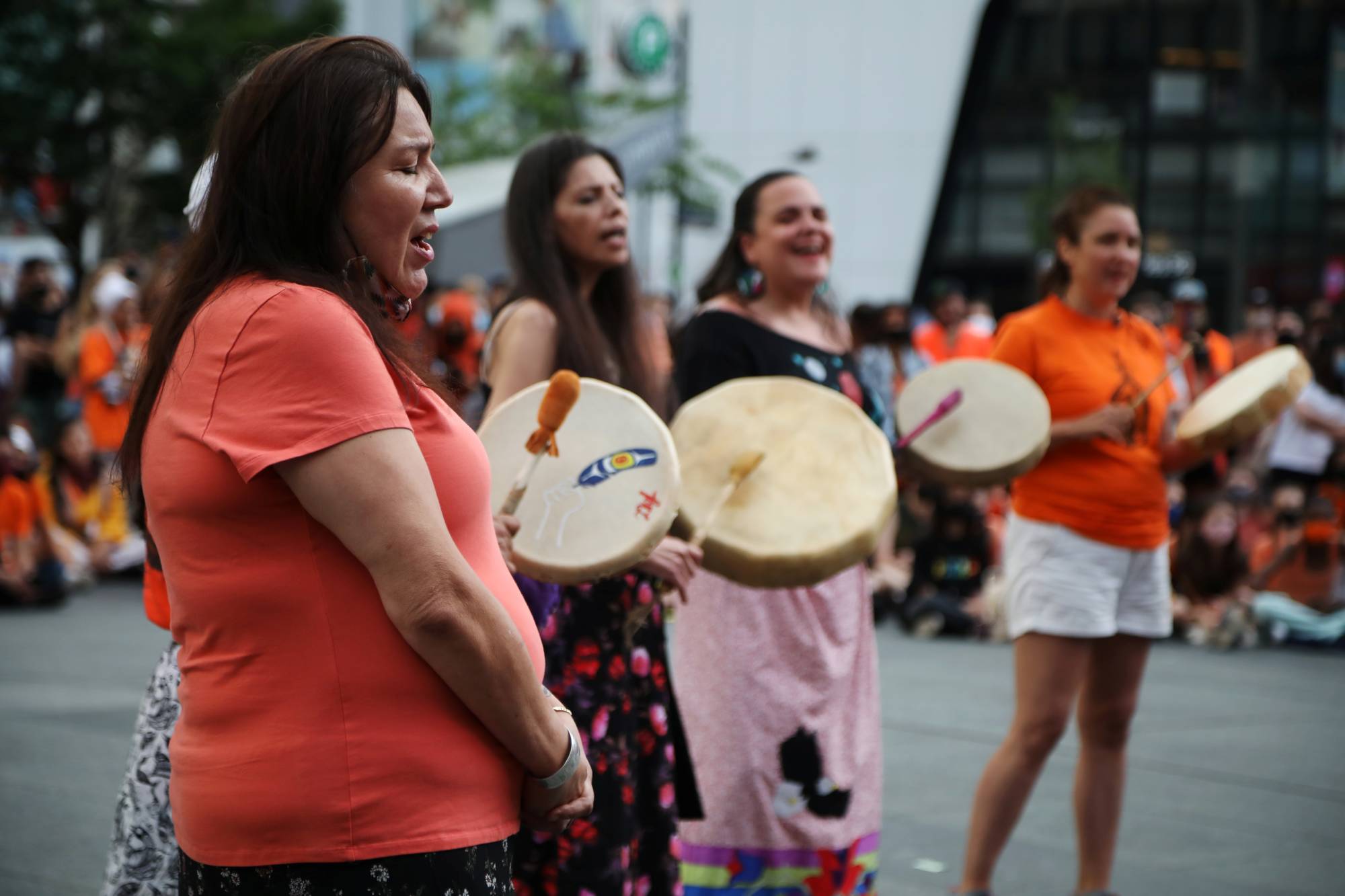 Women sing and play drums in Toronto on Thursday. | REUTERS