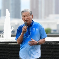 Saburo Kawabuchi speaks to the media during a tour of the Olympic and Paralympic Village. During the event, he scolded the press over its focus on public concerns over holding the games while COVID-19 continues to pose a threat. | REUTERS