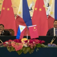 Philippine President Rodrigo Duterte and Chinese President Xi Jinping attend a signing ceremony in Beijing in 2016.  | GETTY IMAGES / VIA BLOOMBERG 