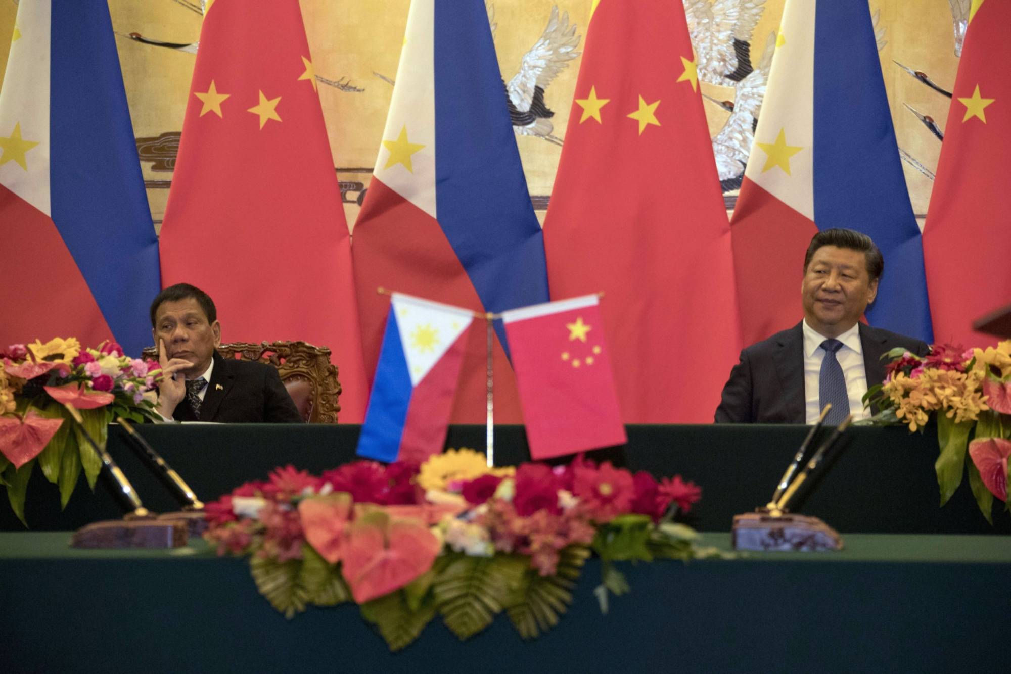 Philippine President Rodrigo Duterte and Chinese President Xi Jinping attend a signing ceremony in Beijing in 2016. | Getty Images / via Bloomberg 