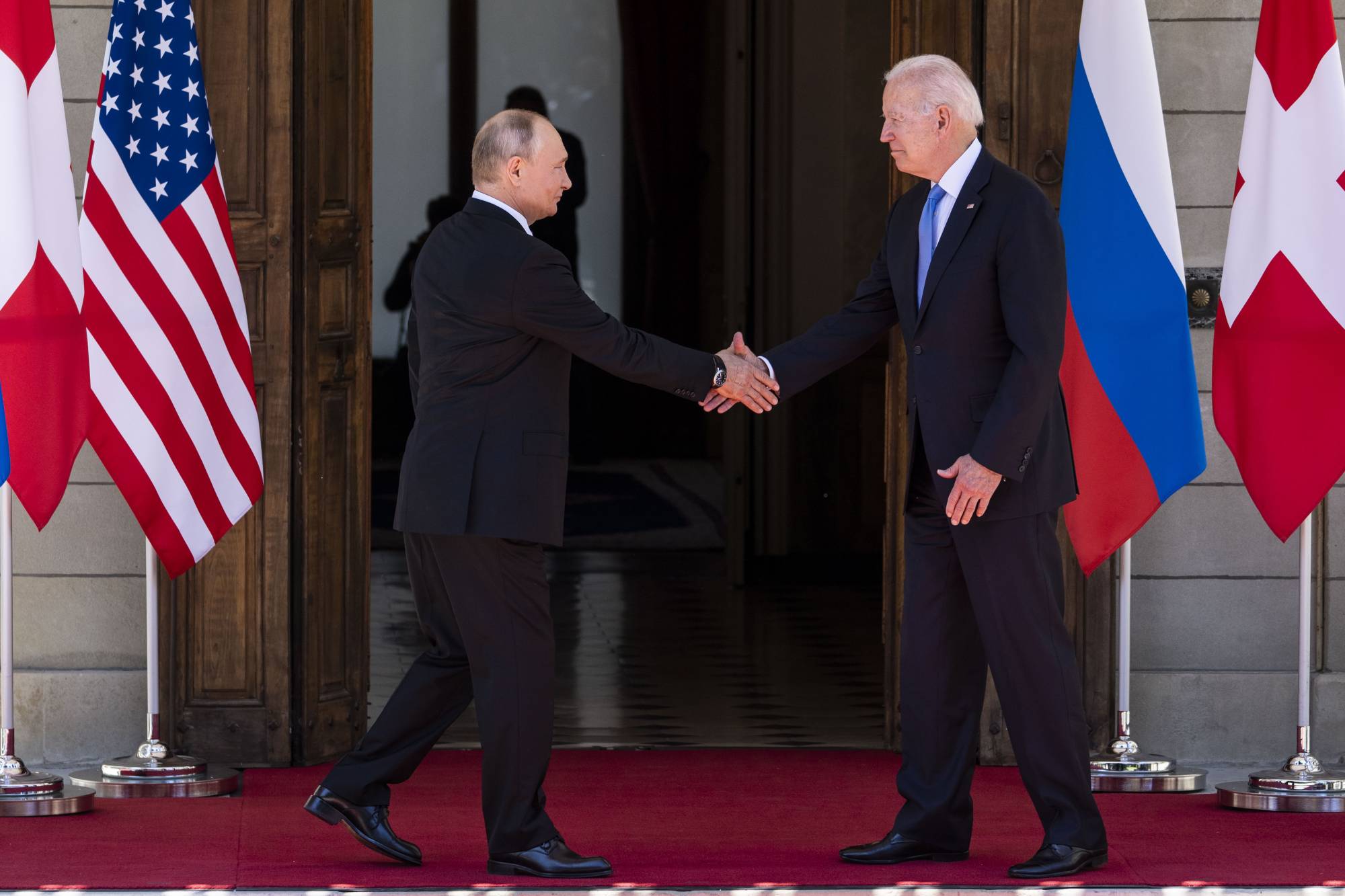 U.S. President Joe Biden and Russian President Vladimir Putin greet ahead their first meeting at the Villa La Grange in Geneva on June 16. | DOUG MILLS / THE NEW YORK TIMES