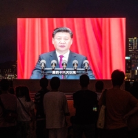 A screen in Hong Kong shows Chinese President Xi Jinping speaking at a light show on July 1 marking the centenary of the Chinese Community Party and the anniversary of Hong Kong\'s return to Chinese rule.  | BLOOMBERG 