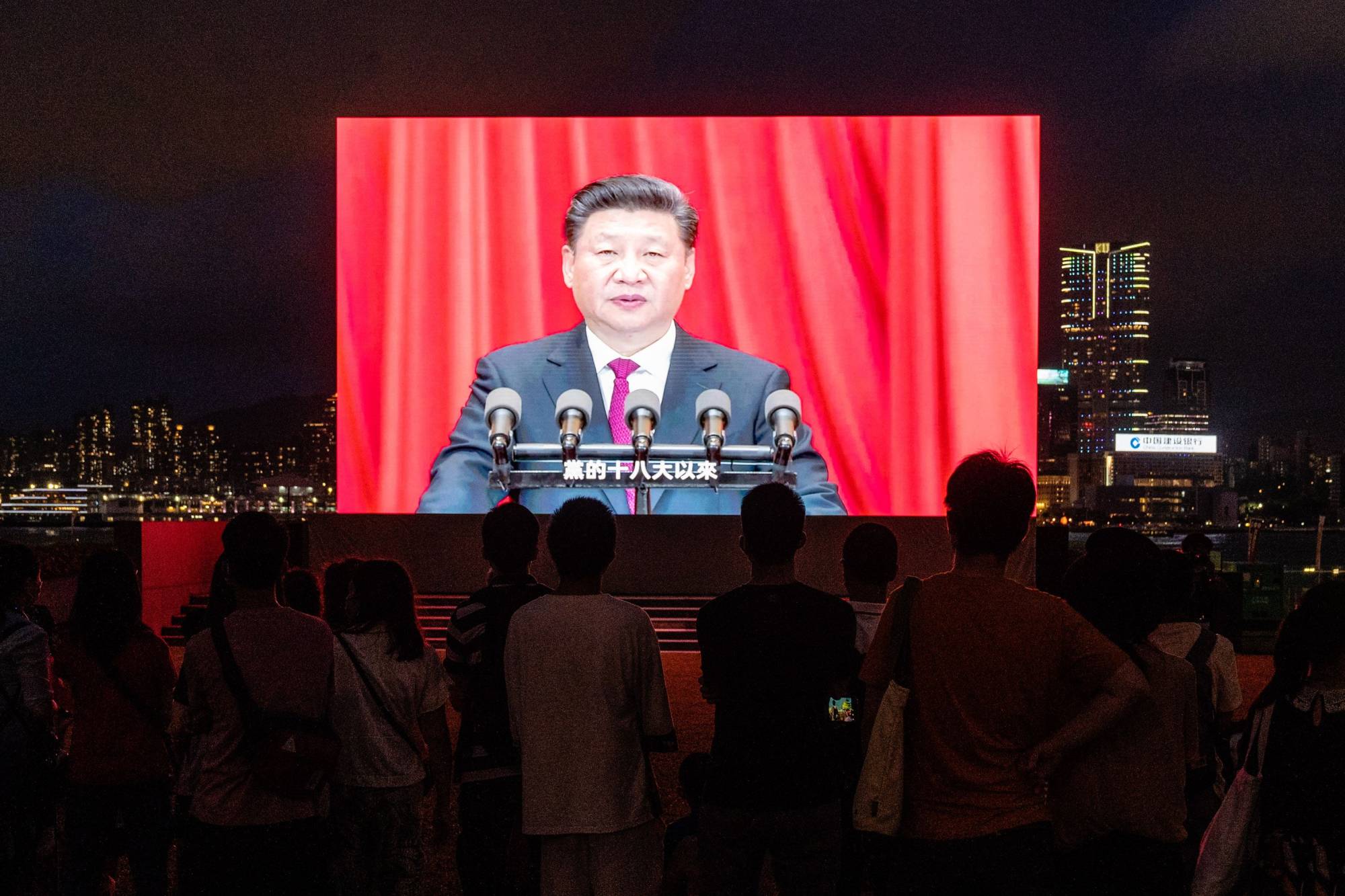 A screen in Hong Kong shows Chinese President Xi Jinping speaking at a light show on July 1 marking the centenary of the Chinese Community Party and the anniversary of Hong Kong's return to Chinese rule. | Bloomberg 