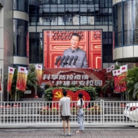 Xi Jinping’s speech at a ceremony for the centenary of the Chinese Communist Party is broadcast live in Shanghai on July 1. | BLOOMBERG 