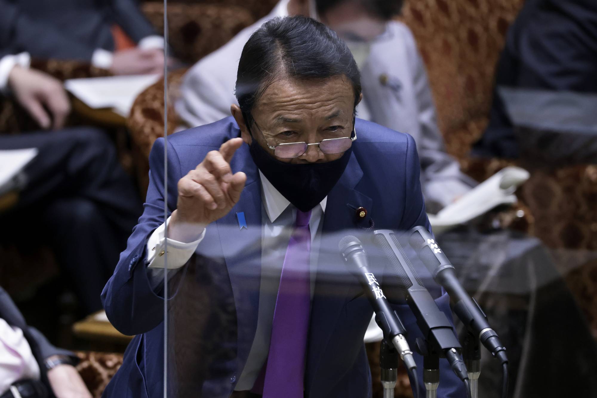 Taro Aso, deputy prime minister and finance minister, speaks during an audit committee session at the Upper House in Tokyo on June 7. | BLOOMBERG