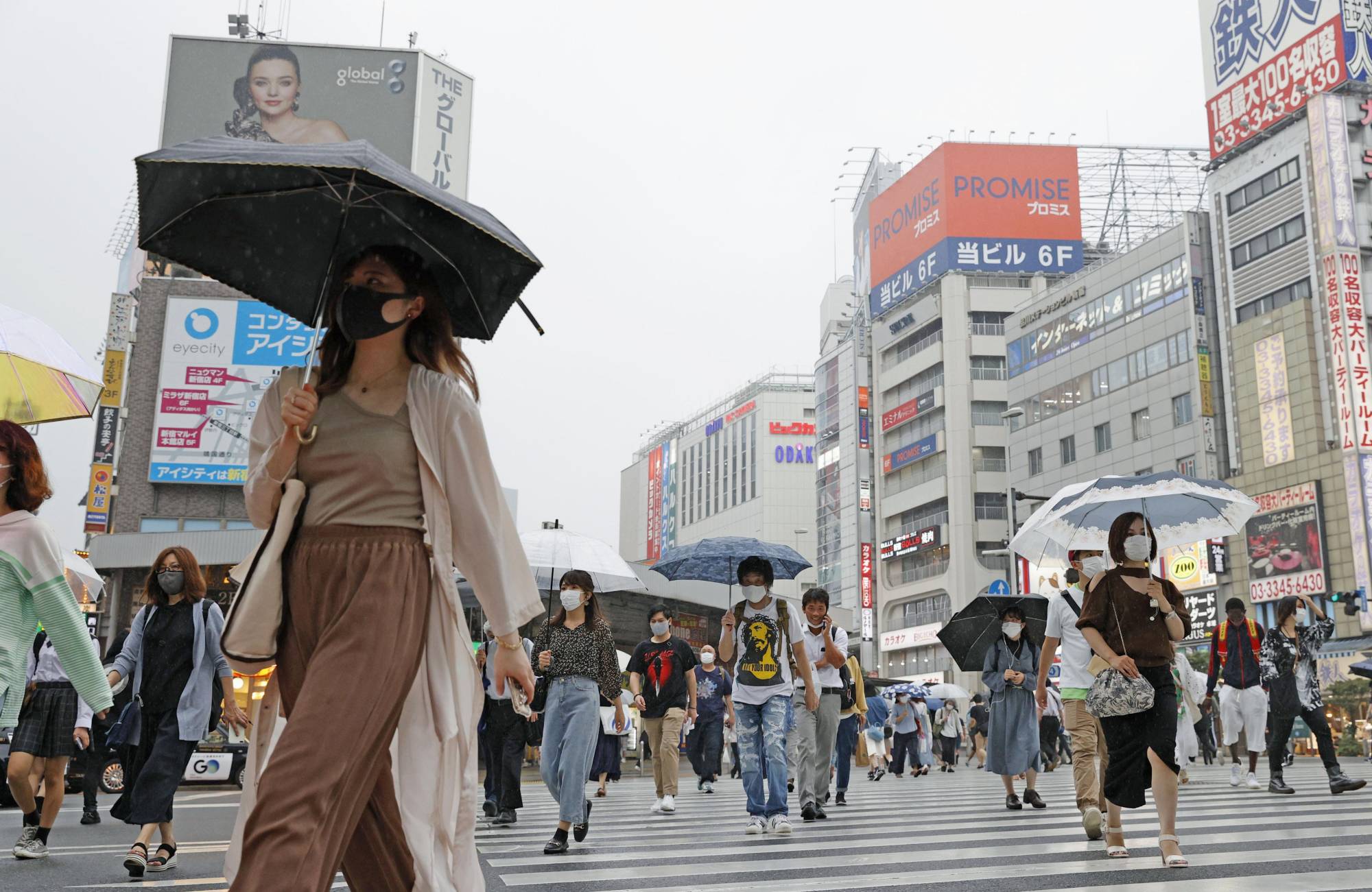 People cross an intersection in Tokyo's Shinjuku Ward on Wednesday. | KYODO