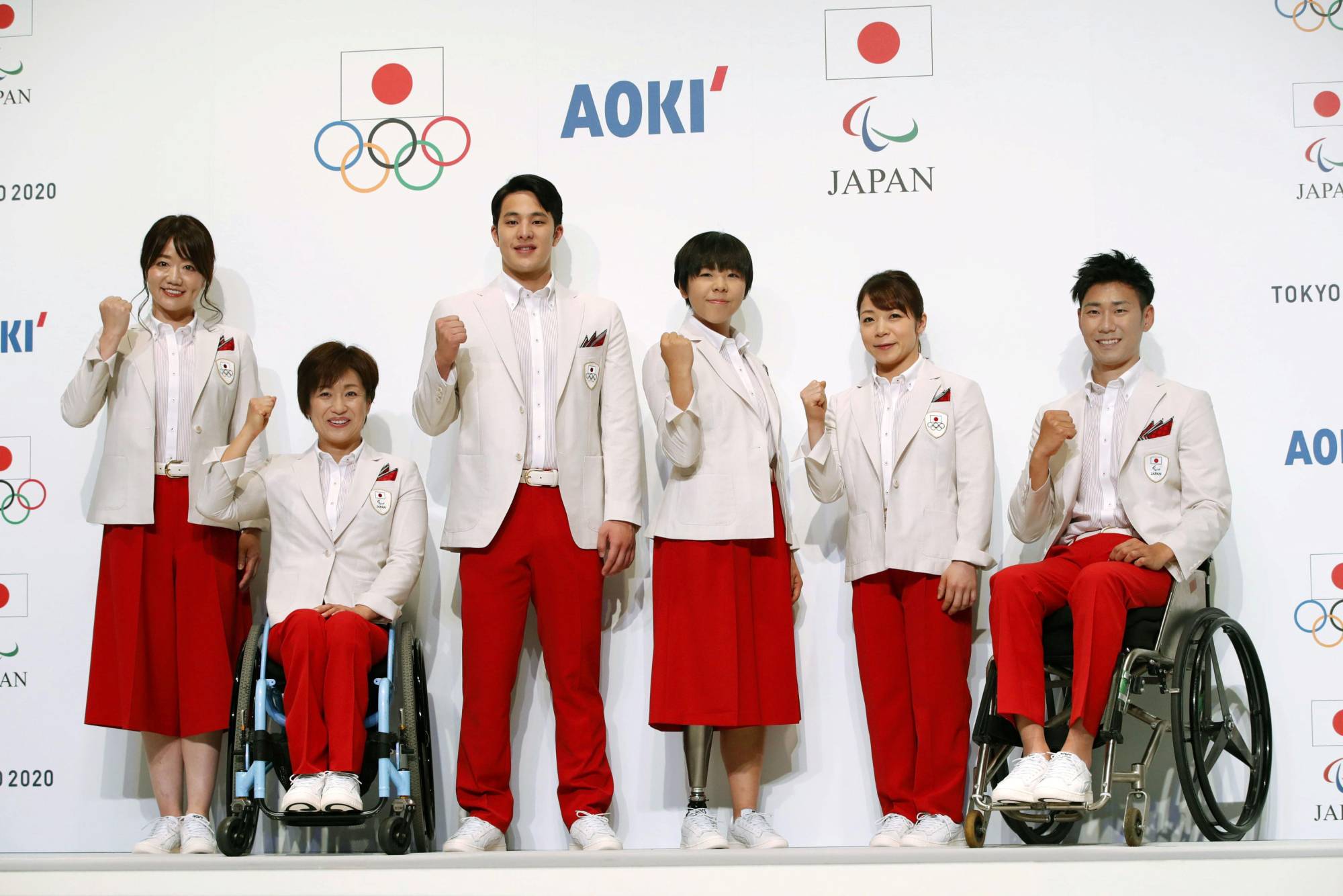 Japanese athletes model the Tokyo Olympics uniforms, which are a riff on the colors and design of the country’s 1964 uniforms. | KYODO / VIA REUTERS