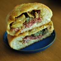 Boulangerie Seiji Asakura’s gyū-cheese karēpan comes loaded with pine nuts and eggplant on a bed of thin-cut beef. | RUSSELL THOMAS
