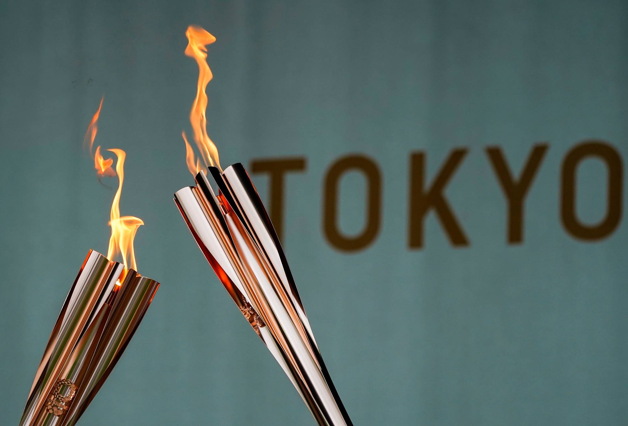 Torches are displayed during a lighting ceremony in Tokyo on Friday after the torch relay on a public road was canceled due to the COVID-19 pandemic. | REUTERS 