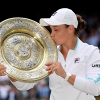 Ash Barty holds the trophy after winning the Wimbledon women\'s singles final against Karolina Plisklova in London on Saturday. | REUTERS