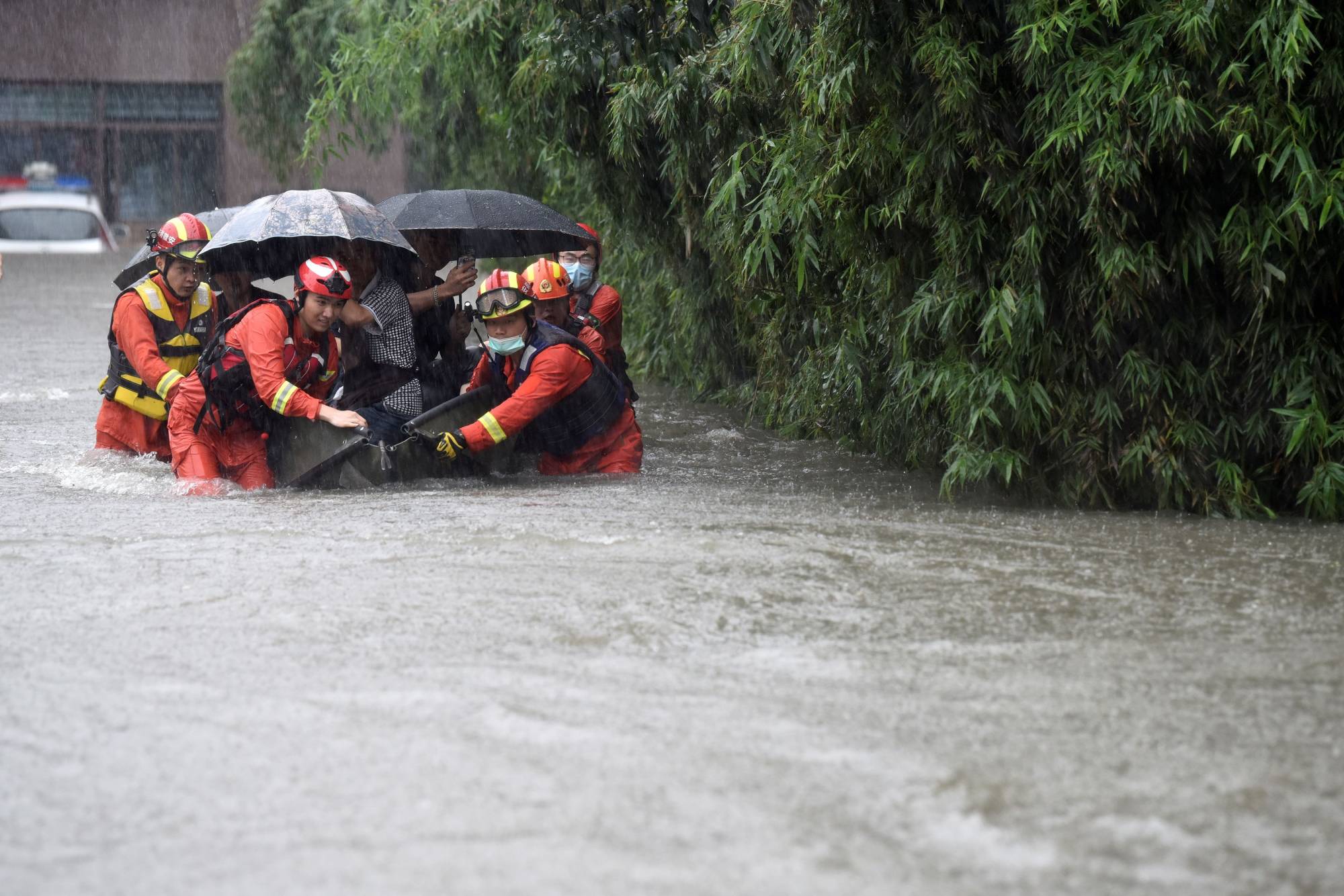 Rescue workers evacuate residents from a flooded area amid heavy rainfall in Hefei, Anhui province, China, on Thursday.    | CHINA DAILY / VIA REUTERS  
