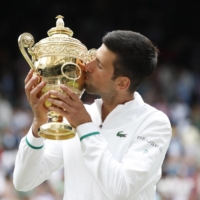 Serbia\'s Novak Djokovic celebrates after winning the Wimbledon final against Italy\'s Matteo Berrettini at the All England Lawn Tennis and Croquet Club in London on Sunday. | REUTERS