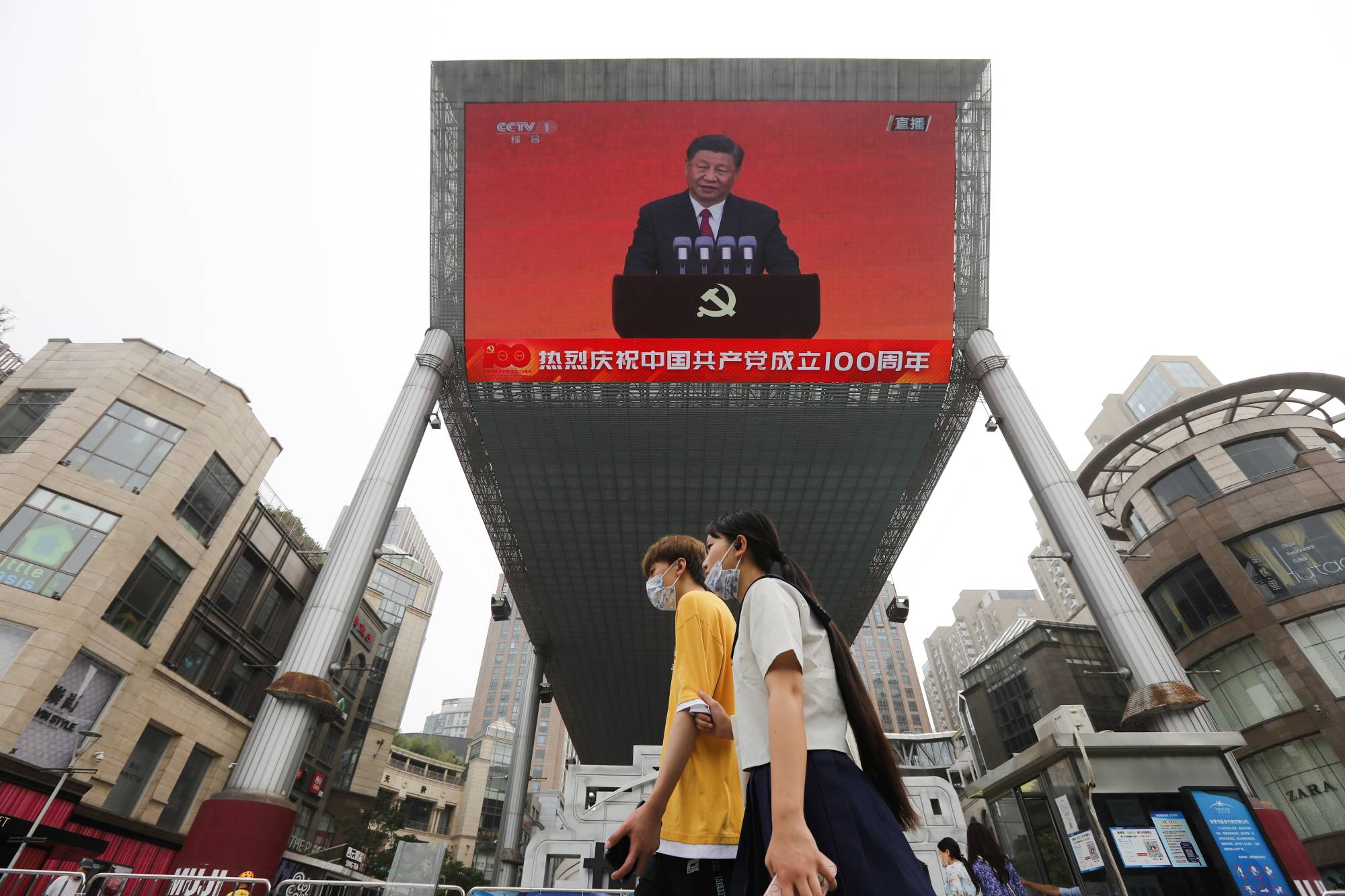 A speech by Chinese President Xi Jinping in shown on a big screen in Beijing on July 1. | REUTERS 