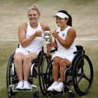 Yui Kamiji and British partner Jordanne Whiley celebrate after winning the Wimbledon wheelchair doubles title on Sunday. | KYODO