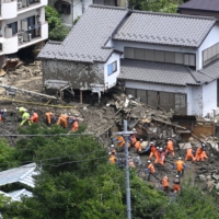 Emergency workers continue to search for the missing in the mudslide-hit city of Atami, Shizuoka Prefecture, on Monday following the July 3 disaster. | KYODO