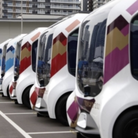Toyota\'s e-Palette vehicles at the Tokyo 2020 Olympic Village. The automaker is planning a hiring push. | BLOOMBERG