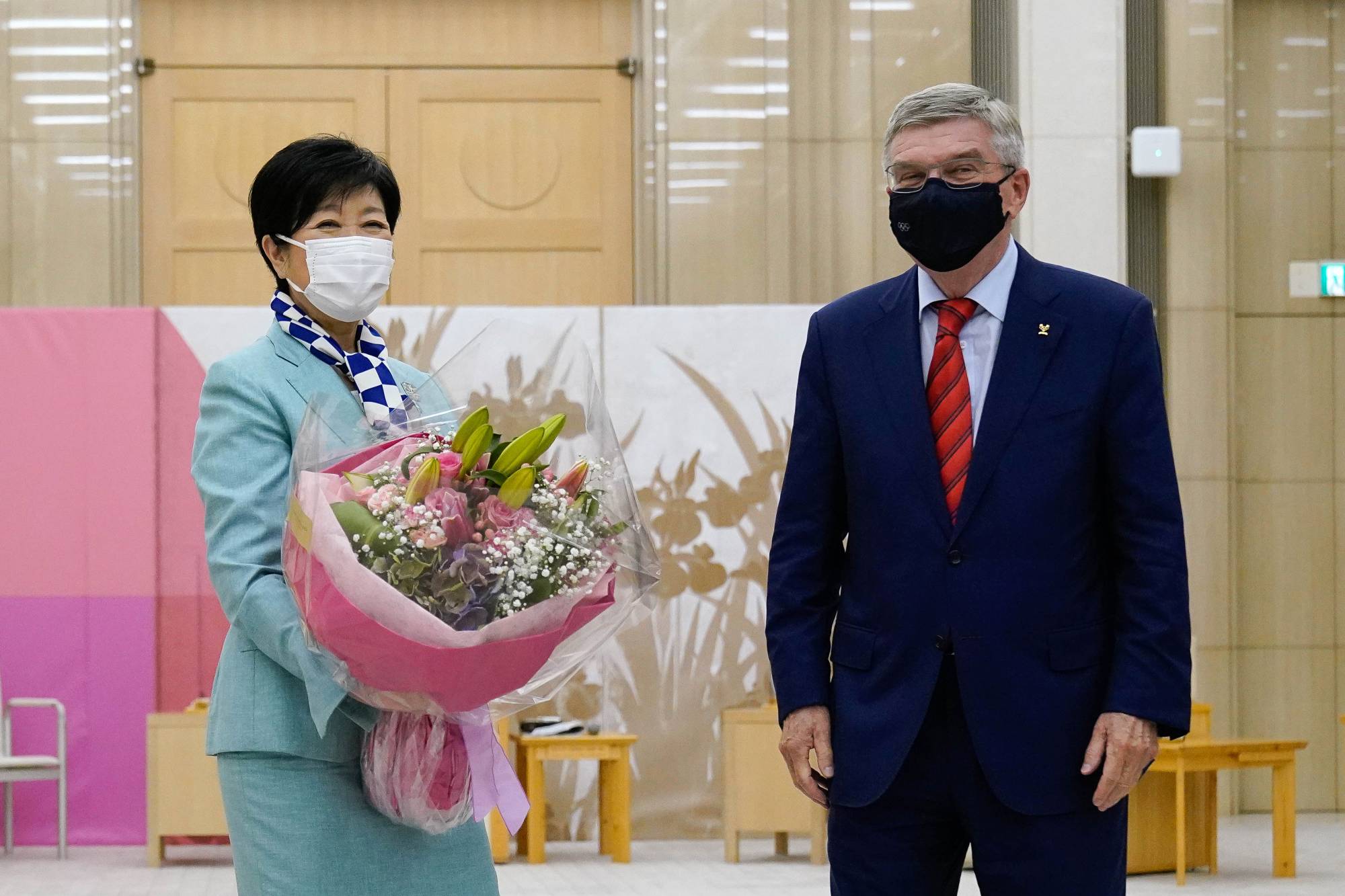 Thomas Bach (right), president of the International Olympic Committee, meets with  Tokyo Gov. Yuriko Koike in Tokyo on Thursday. |  BLOOMBERG