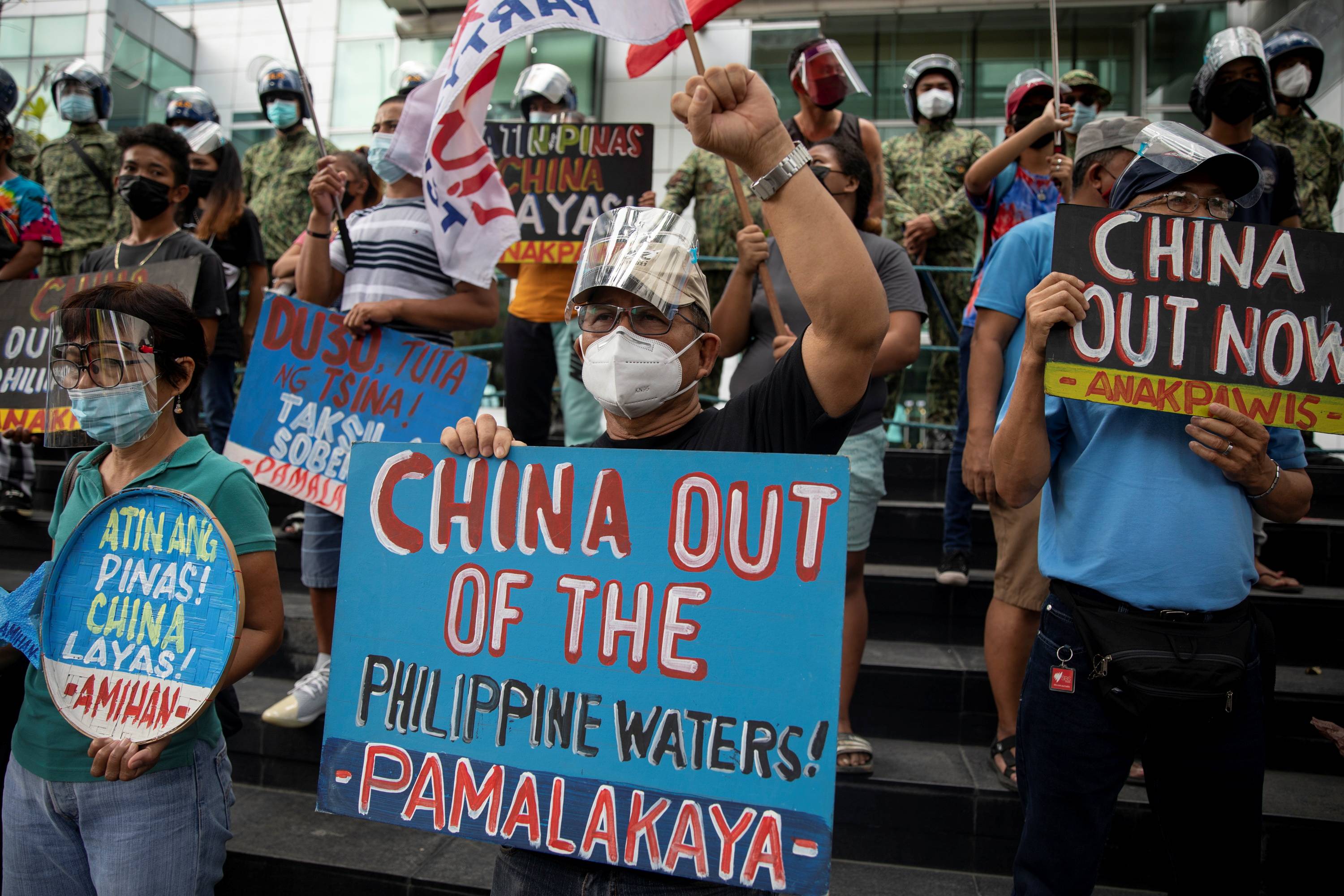 Activists stage a protest outside the Chinese Consulate on the fifth anniversary of an international court of arbitration ruling that invalidated Beijing's historical claims over the waters of the South China Sea, in Makati City, Philippines, on Monday.   | REUTERS 