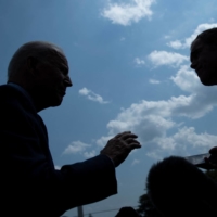 U.S. President Joe Biden talks to reporters while walking to Marine One on the South Lawn of the White House in Washington on Friday. | AFP-JIJI