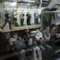 Commuters ride a train on Tokyo\'s Yamanote Line on Thursday, three days after a fourth state of emergency was declared in the capital. | RYUSEI TAKAHASHI
