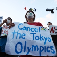 People protest against the Tokyo Olympic Games outside the Akasaka State Guest House, where International Olympic Committee President Thomas Bach attended a welcome ceremony on Sunday. | REUTERS