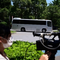 A bus believed to be carrying Michael and Peter Taylor | AFP-JIJI