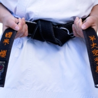 Karateka Sakura Kokumai, who will compete for the United States during the Olympics, ties her belt. | ROBERT HANASHIRO / USA TODAY / VIA REUTERS