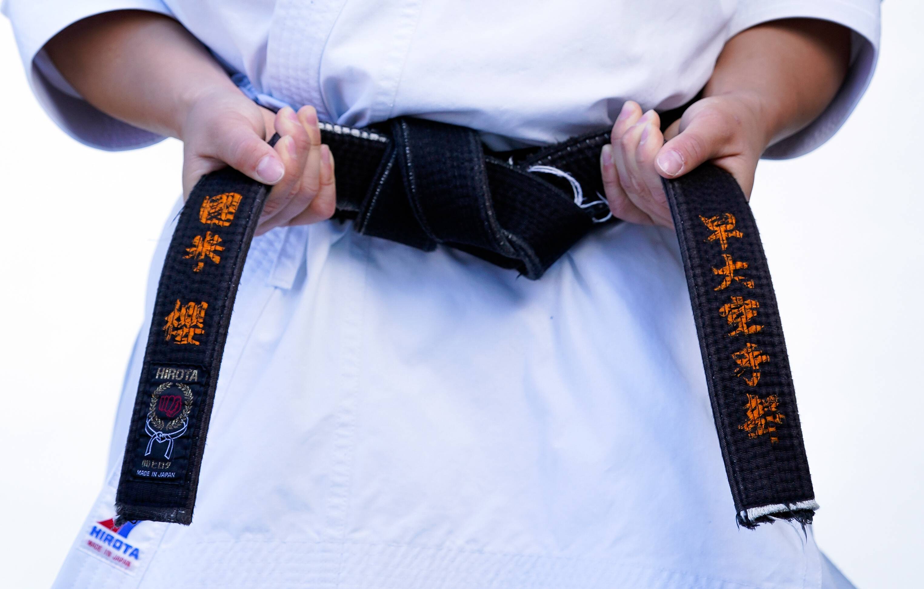 Karateka Sakura Kokumai, who will compete for the United States during the Olympics, ties her belt. | ROBERT HANASHIRO / USA TODAY / VIA REUTERS