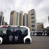 Toyota’s e-Palette autonomous electric vehicles at the Olympic and Paralympic Village in Tokyo.  | BLOOMBERG