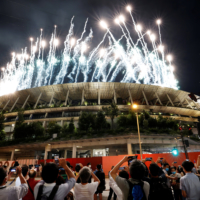 People take pictures of fireworks during the opening ceremony of the Paralympic Games from outside the National Stadium. | REUTERS