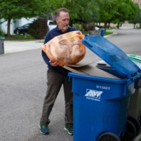 David Garman places his orange Hefty EnergyBag into his recycling bin in Boise, Idaho, on May 21.  | REUTERS