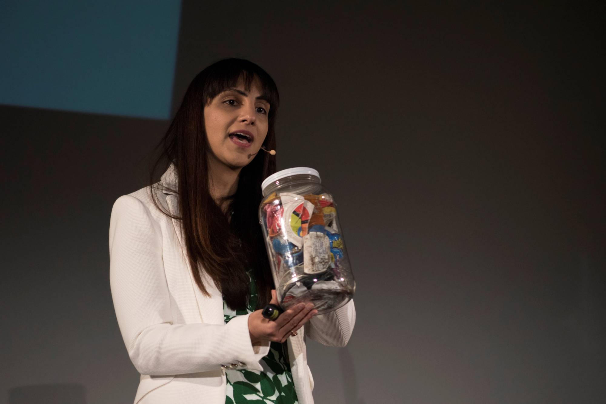 Priyanka Bakaya, founder of Renewlogy, holds a jar of mixed recyclables as she speaks at the 2015 TEDx Amherst event at the University of Massachusetts in April 2015. | Cade Belisle / The Massachusetts Daily Collegian / Via REUTERS
