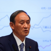 Prime Minister Yoshihide Suga attends a news conference on Japan\'s response to the coronavirus pandemic, at his official residence in Tokyo on Friday. | POOL / VIA REUTERS