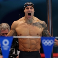 Caeleb Dressel of the United States yells during the men\'s 4x100-meter medley relay final at Tokyo Aquatics Centre on Sunday. The U.S. won gold in a world record time. | REUTERS