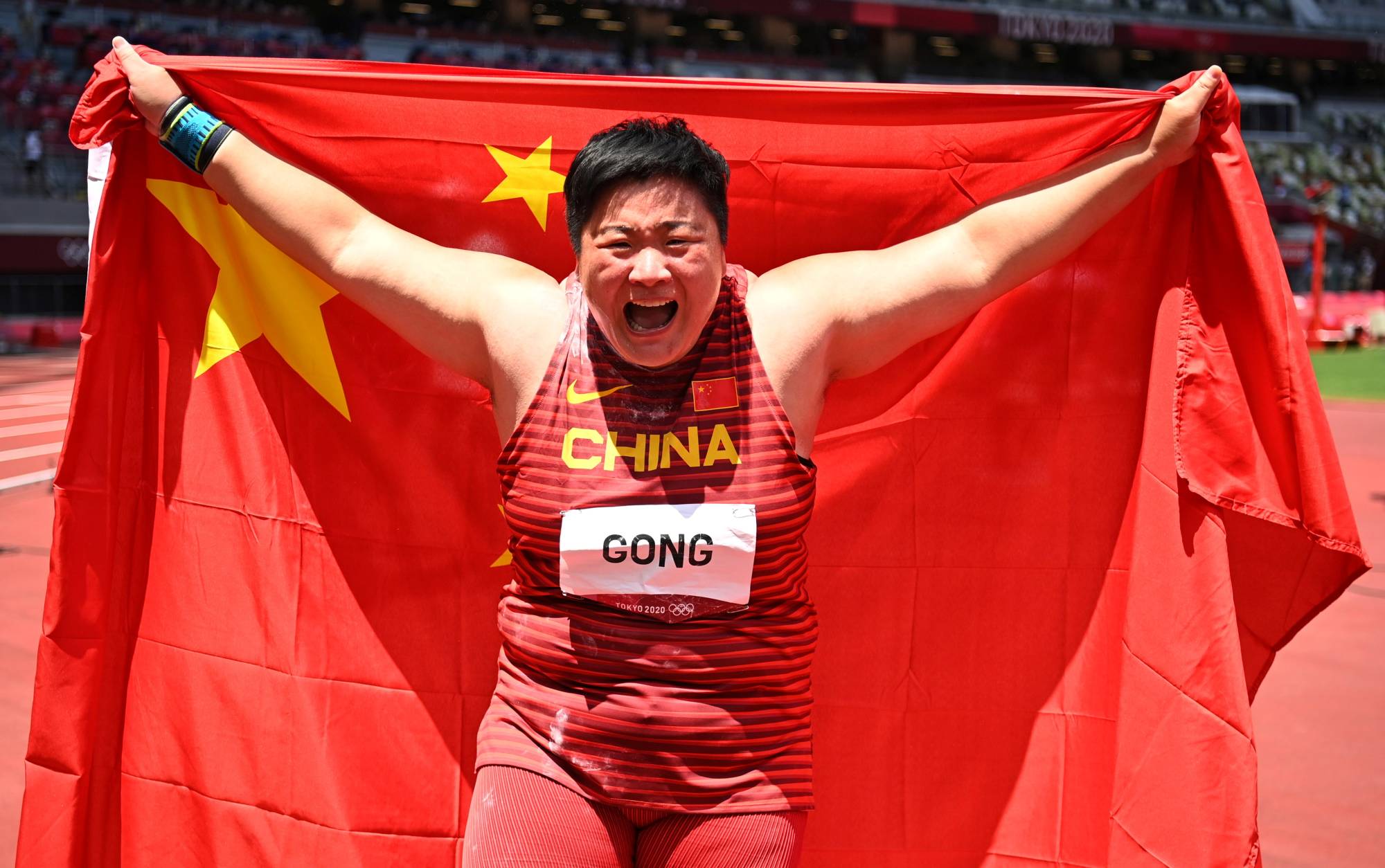 China's Gong Lijiao celebrates after winning gold in the women's shot put on Sunday at National Stadium. | REUTERS