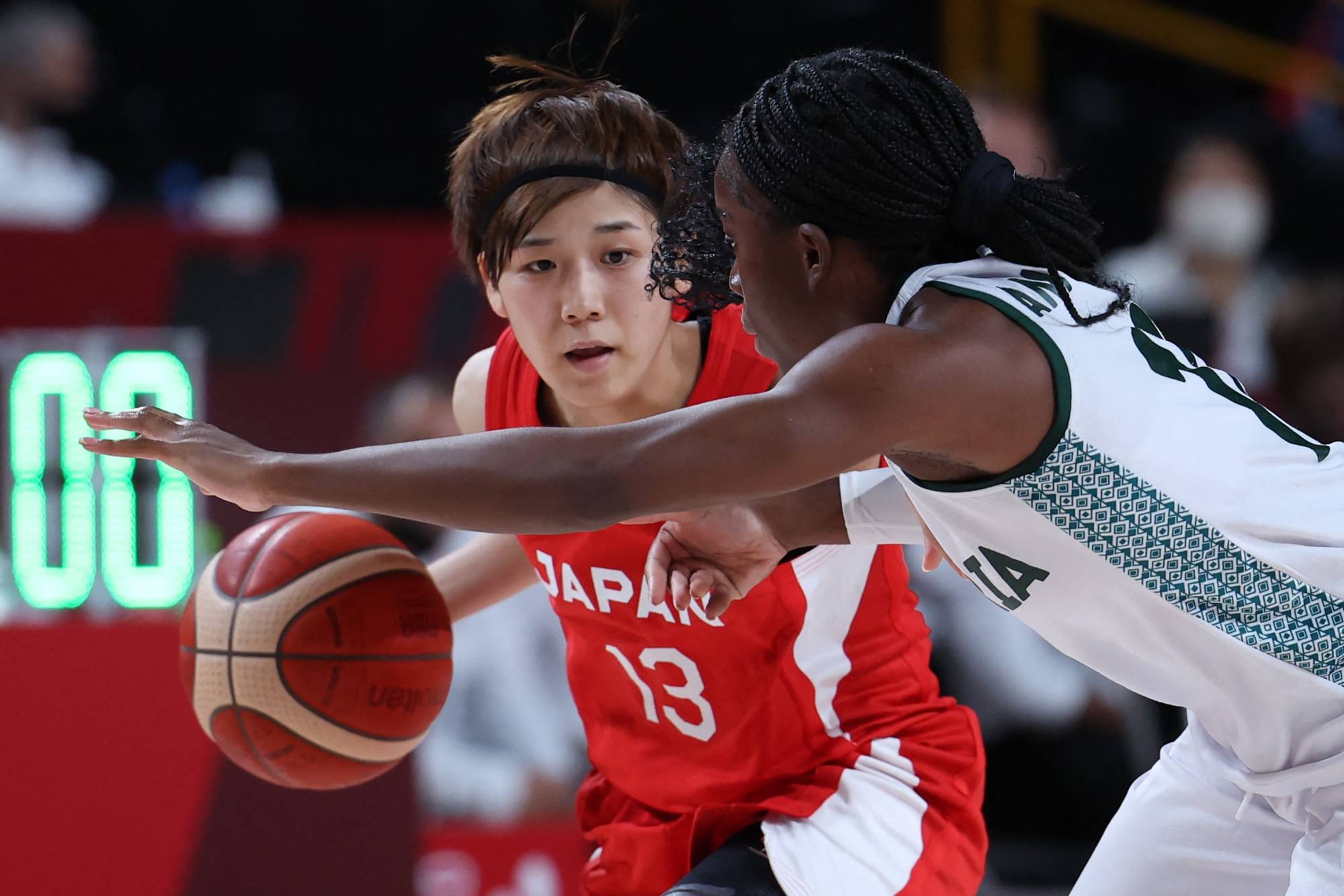 Japan's Rui Machida dribbles the ball past Nigeria's Promise Amukamara in the two nations' Group B Olympic match at Saitama Super Arena on Monday. | AFP-JIJI
