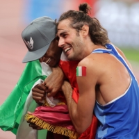 Mutaz Essa Barshim (left) of Qatar and Gianmarco Tamberi of Italy celebrate after winning gold in the men\'s high jump final during the Tokyo Olympics on Sunday. | REUTERS