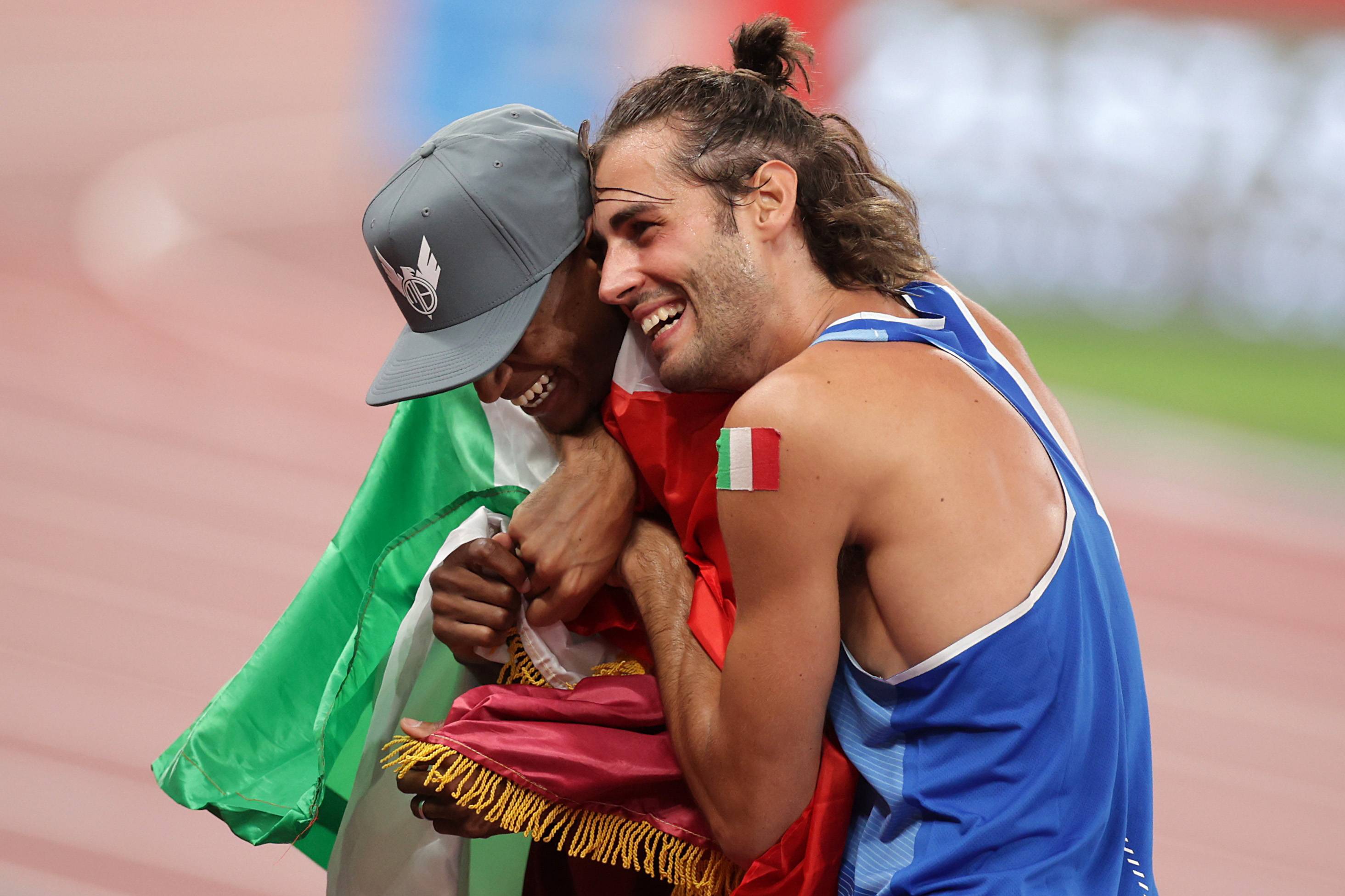 Mutaz Essa Barshim (left) of Qatar and Gianmarco Tamberi of Italy celebrate after winning gold in the men's high jump final during the Tokyo Olympics on Sunday. | REUTERS