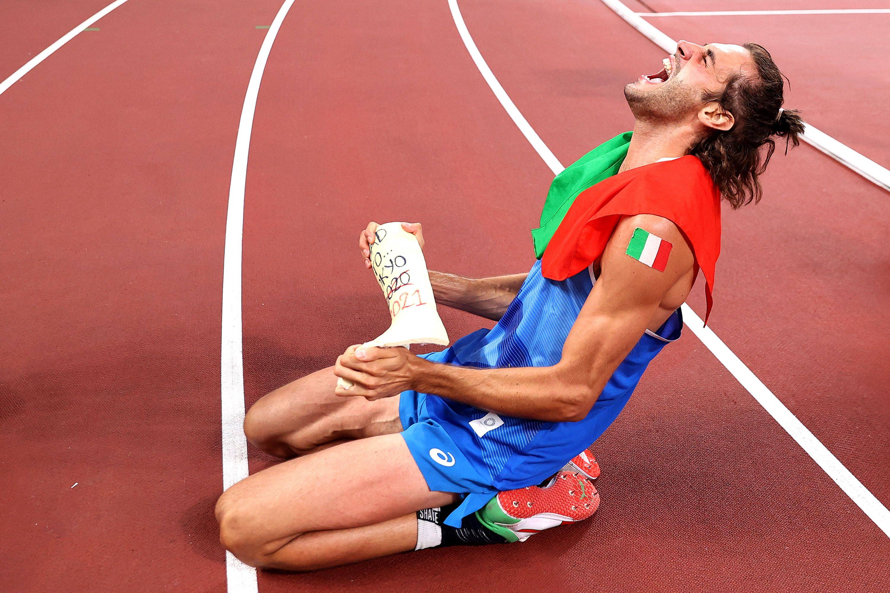 Italy's Gianmarco Tamberi celebrates on the track following the men's high jump final during the Tokyo Olympics at the National Stadium in the capital on Sunday. | POOL / VIA AFP-JIJI