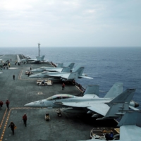 F/A-18 Hornet fighter jets and E-2D Hawkeye plane are seen on the U.S. aircraft carrier John C. Stennis during the Malabar joint military exercises off Okinawa Prefecture in June 2016. | REUTERS