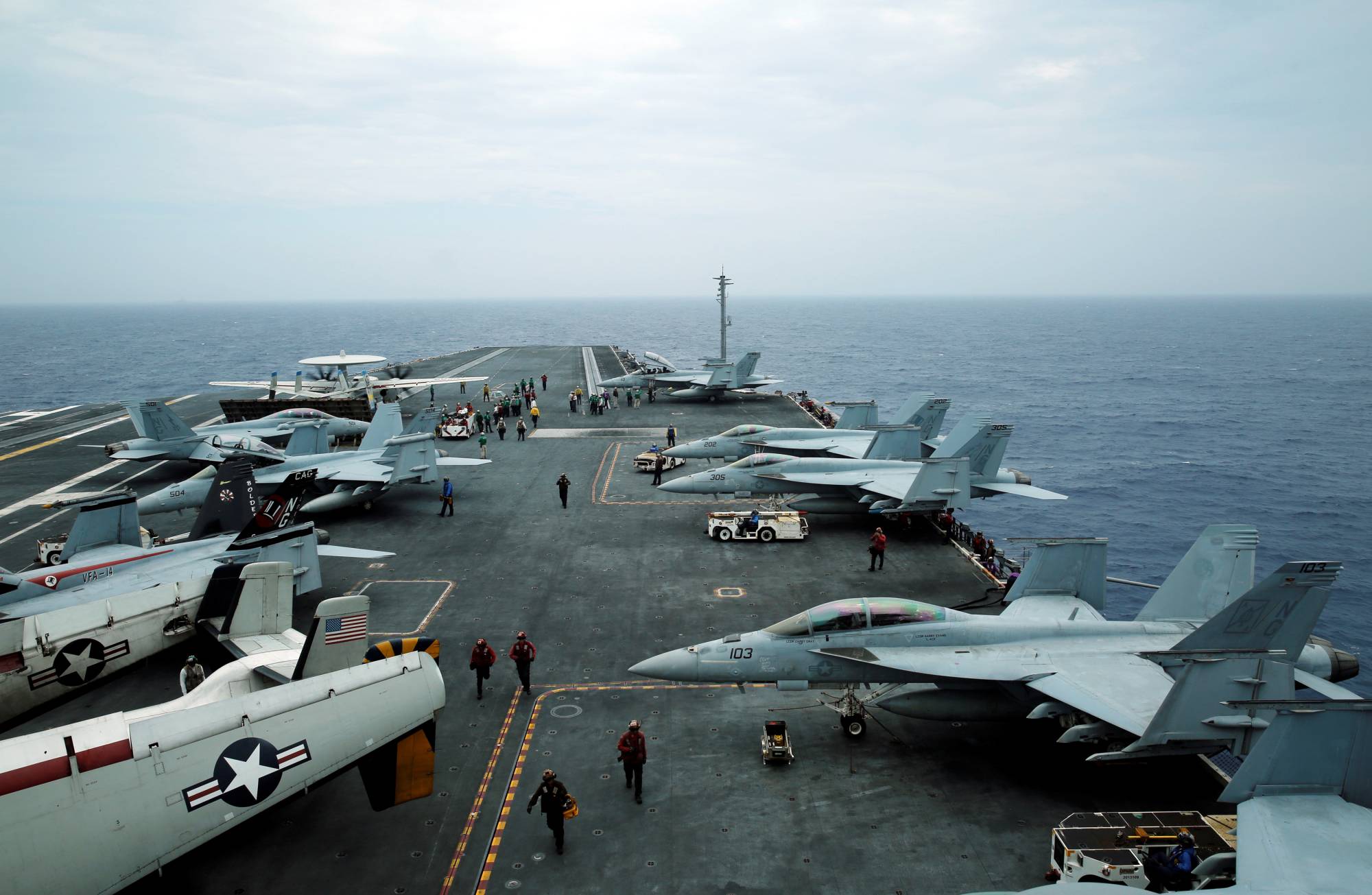 F/A-18 Hornet fighter jets and E-2D Hawkeye plane are seen on the U.S. aircraft carrier John C. Stennis during the Malabar joint military exercises off Okinawa Prefecture in June 2016. | REUTERS