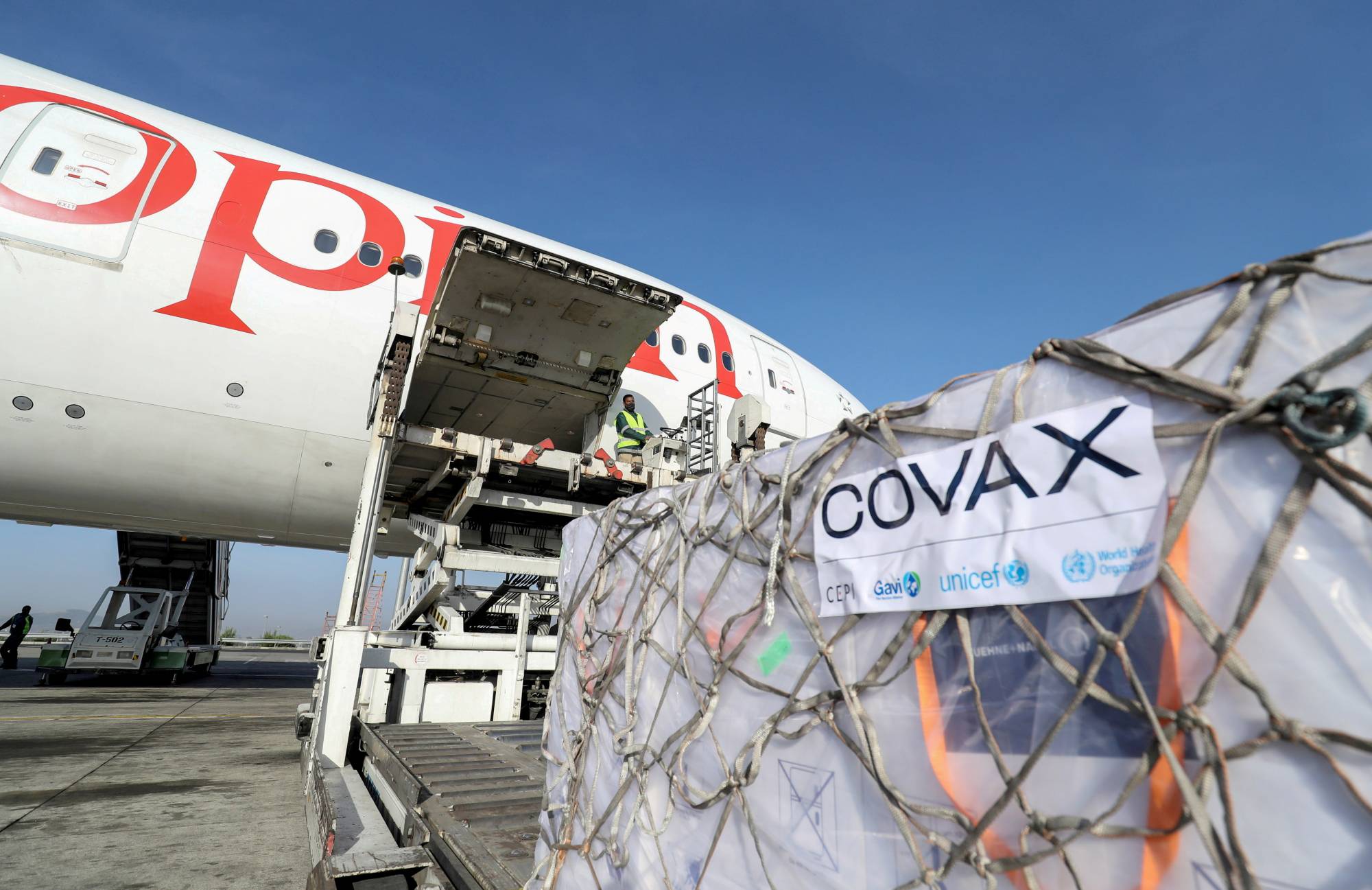 Ethiopian Airlines staff unload vaccine supplies provided through the COVAX system at Bole International Airport in Addis Ababa, Ethiopia, in March. | Reuters 