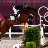 Jose Maria Larocca of Argentina competes in the qualification round of equestrian jumping with his horse, Finn Lente. | REUTERS