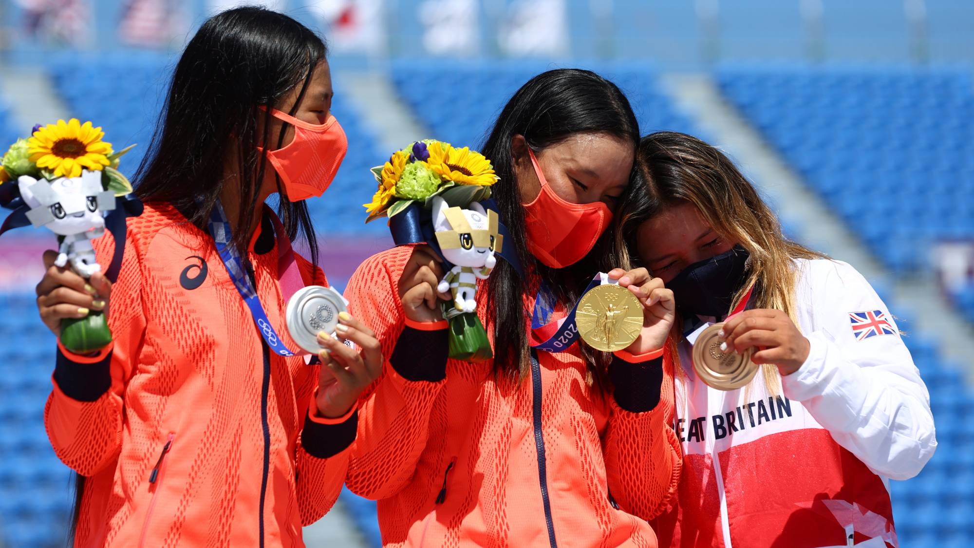 Gold medalist Sakura Yosozumi of Japan celebrates on the podium next to teammate and silver medalist Kokona Hiraki and bronze medalist Sky Brown of Britain.  | REUTERS