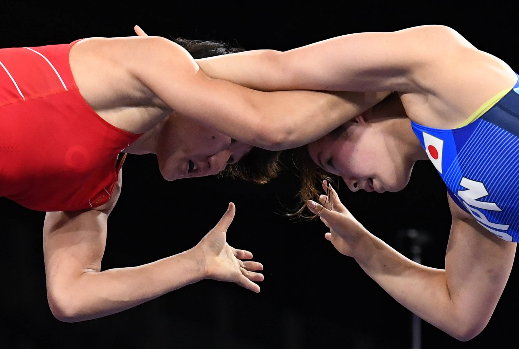 Yukako Kawai of Japan wrestles Aisuluu Tynybekova of Kyrgyzstan in the women's 62 kg freestyle final at Makuhari Messe in Chiba Prefecture on Wednesday. | REUTERS