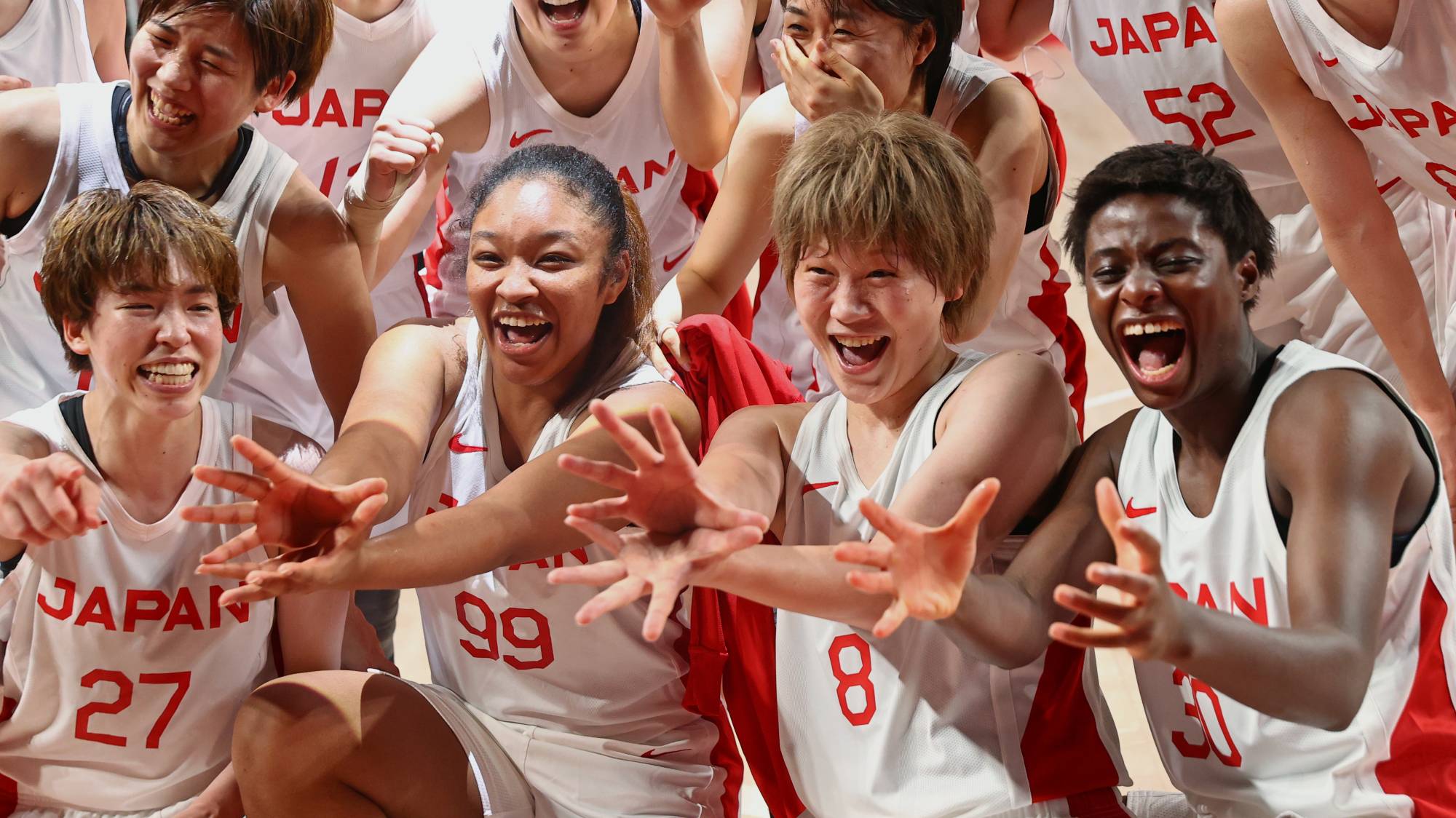 The Japanese women's basketball team celebrates after defeating Belgium in their quarterfinal Olympic basketball match at Saitama Super Arena in Saitama on Wednesday. | REUTERS