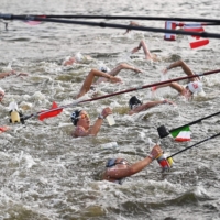 Swimmers at a feed station along the course during the women\'s 10-km marathon swimming event | AFP-JIJI